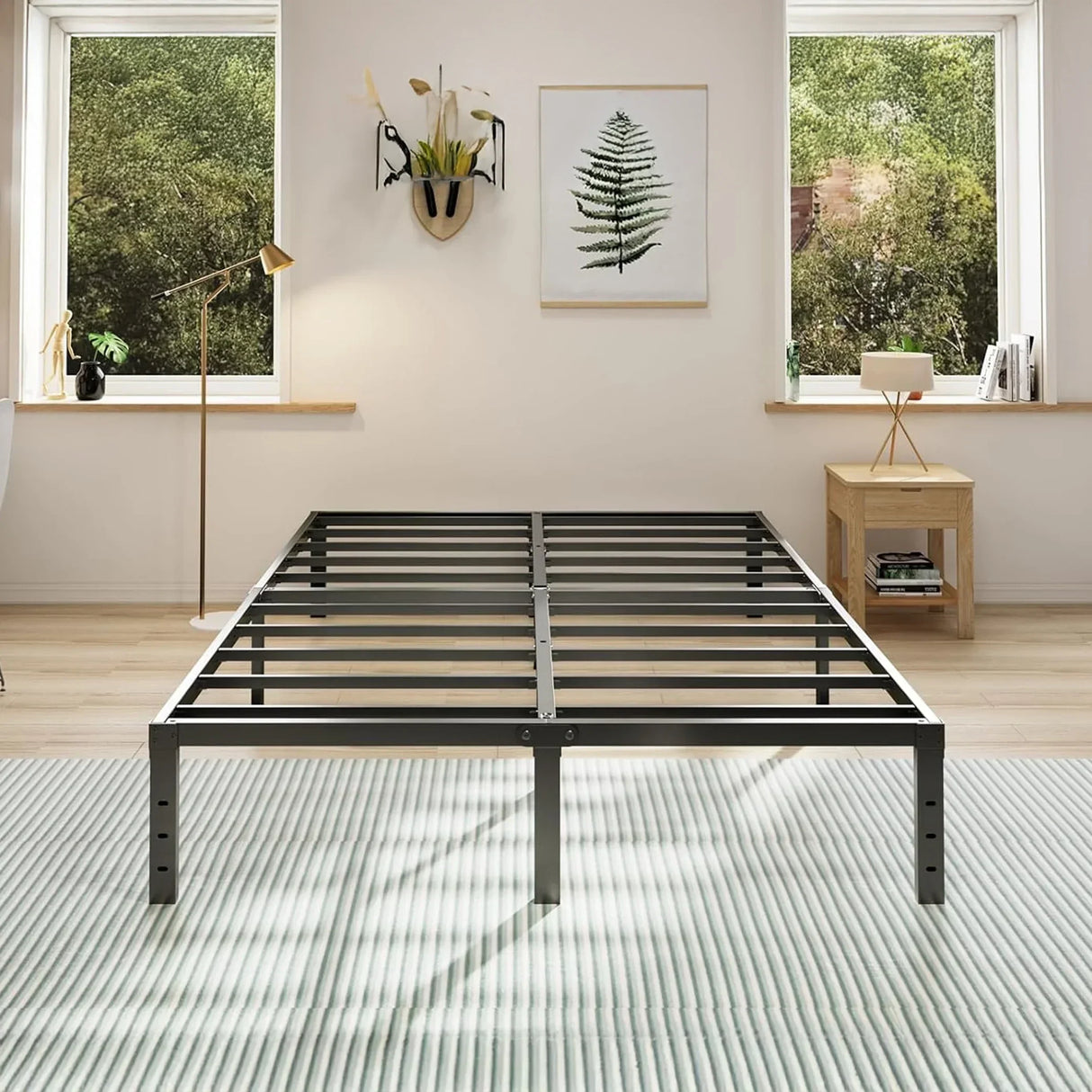 Modern black metal bed frame in a bright bedroom with wooden decor and green outdoor view