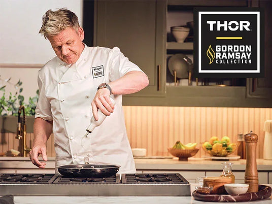 Chef in kitchen pouring oil in pan on Thor Kitchen range, Gordon Ramsay Collection logo visible