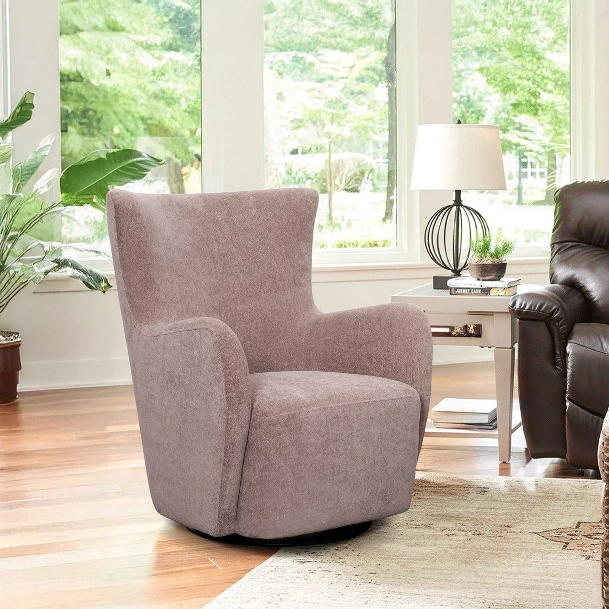 Modern ash gray swivel accent chair in bright living room with large windows and wood floor