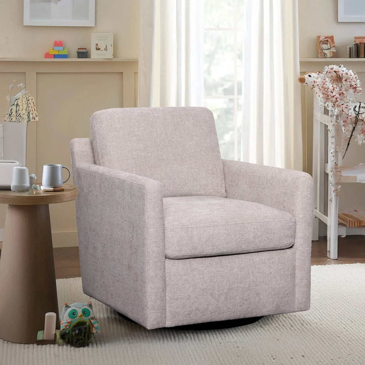 Modern stone gray swivel armchair in bright living room with side table and plush rug
