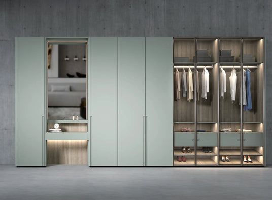 Modern wardrobe with light teal cabinet doors, integrated mirror, open closets with clothes and shoes