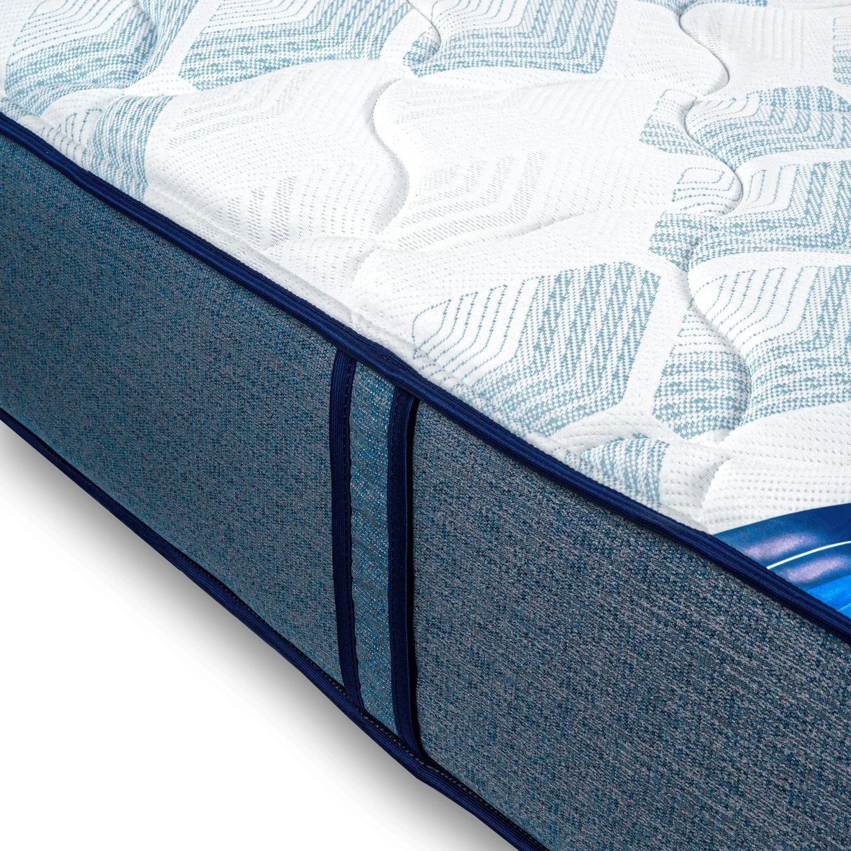 Close-up of a blue and white memory foam mattress with textured fabric and side handles