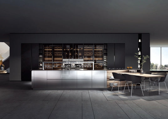 Modern kitchen with stainless steel island, black cabinets, wine storage, and dining table with chairs