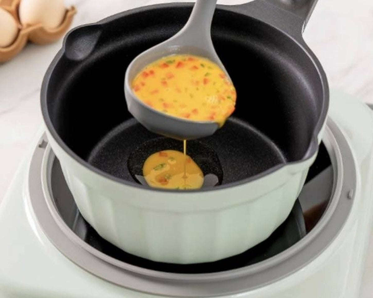 BUYDEEM CP143 Non-Stick Milk Pan 20cm with Glass Lid – green 20 cm pan on an induction cooker, ladle pouring egg