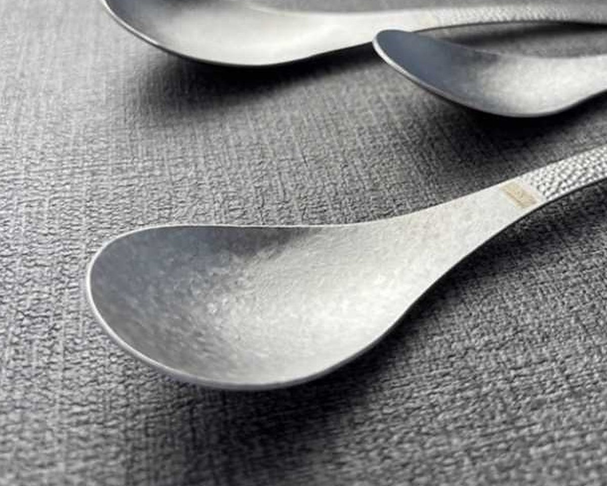 SNF Pure Titanium Chopsticks & Spoon Set – 8 Pieces – close-up of spoons with hammered handles on dark mat