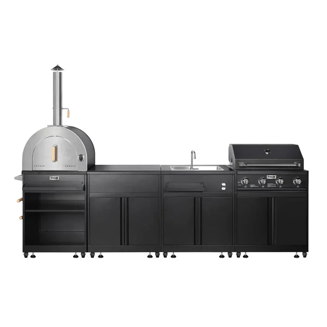 Modern black outdoor kitchen setup with stainless steel pizza oven, sink, and gas grill