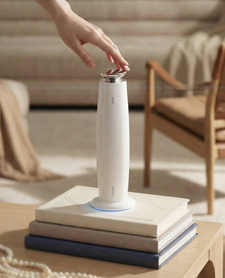 3004 H3mini Desktop Aroma Diffuser Gift Set – Lacquer White – hand on top of white H3mini standing on books in a sunlit living room