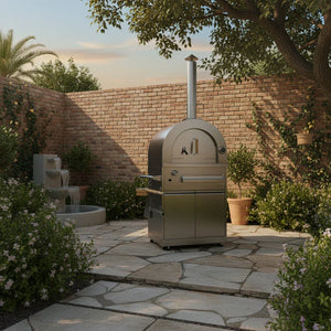 Stainless steel outdoor pizza oven in a stone patio garden with brick wall and fountain