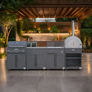 Modern outdoor kitchen with stainless steel grill, pizza oven, sink and garden lighting