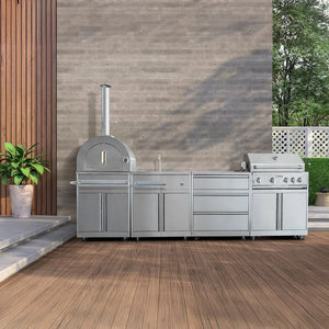 Outdoor kitchen with pizza oven, sink, and grill on a wooden deck.