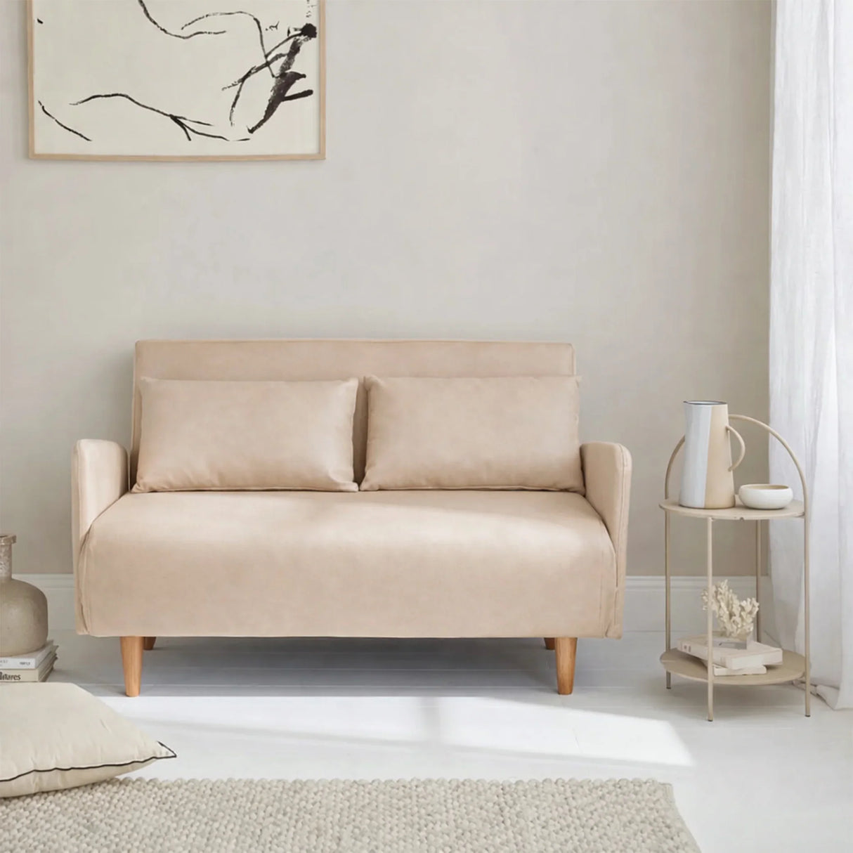 Beige convertible sofa bed in modern living room with side table and abstract wall art, HOCC UAE