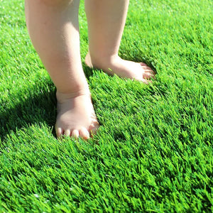 Baby feet on lush artificial grass, soft turf outdoor, HOCC UAE home decor