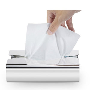 LUXMOOD Flow Stainless Steel Tissue Box – hand pulling a tissue from the top opening, on white