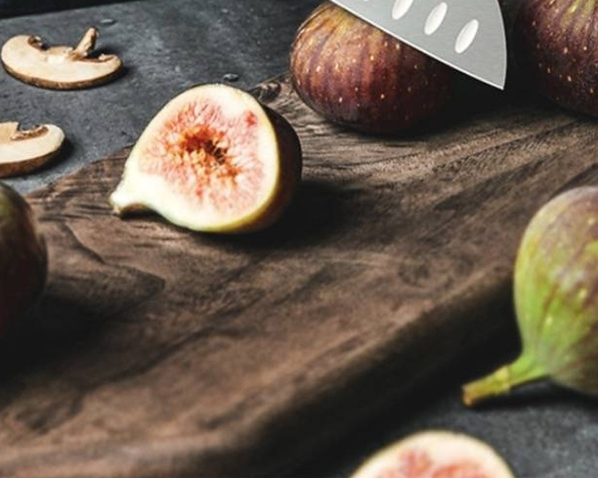 SNF MS2 Avant Classic 7-Inch Santoku Knife – Olive Wood – figs and mushrooms on a dark wooden board, santoku blade tip at top